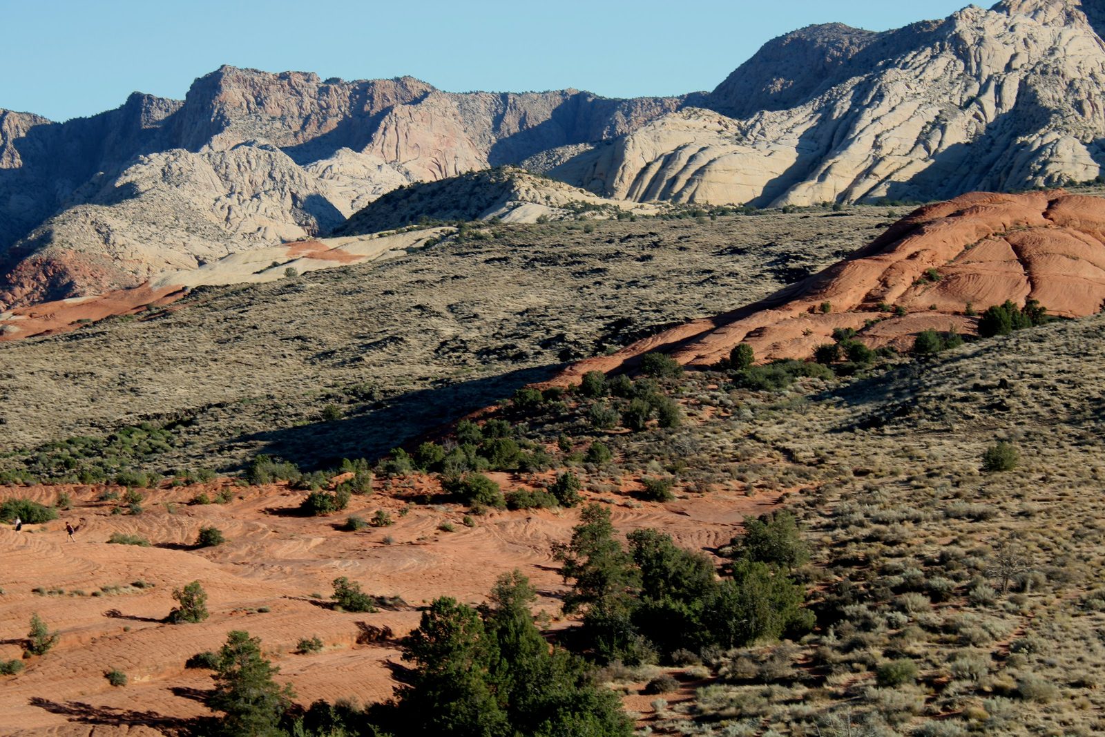 Red sandstone domes and sage covered hills below the white cliffs of Snow Canyon near St. George